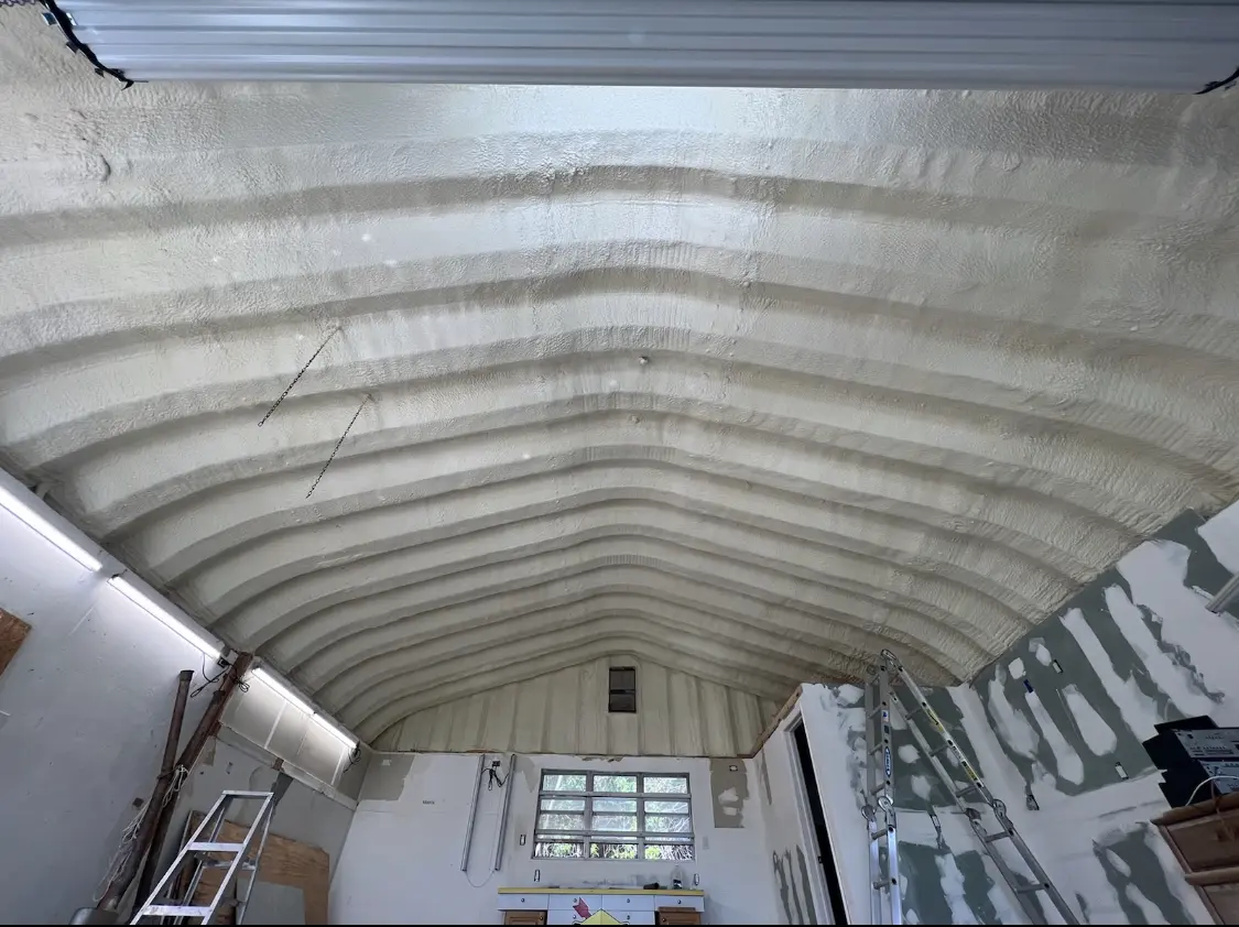 Spray polyurethane foam applied to the underside of a metal roof deck in Norcross